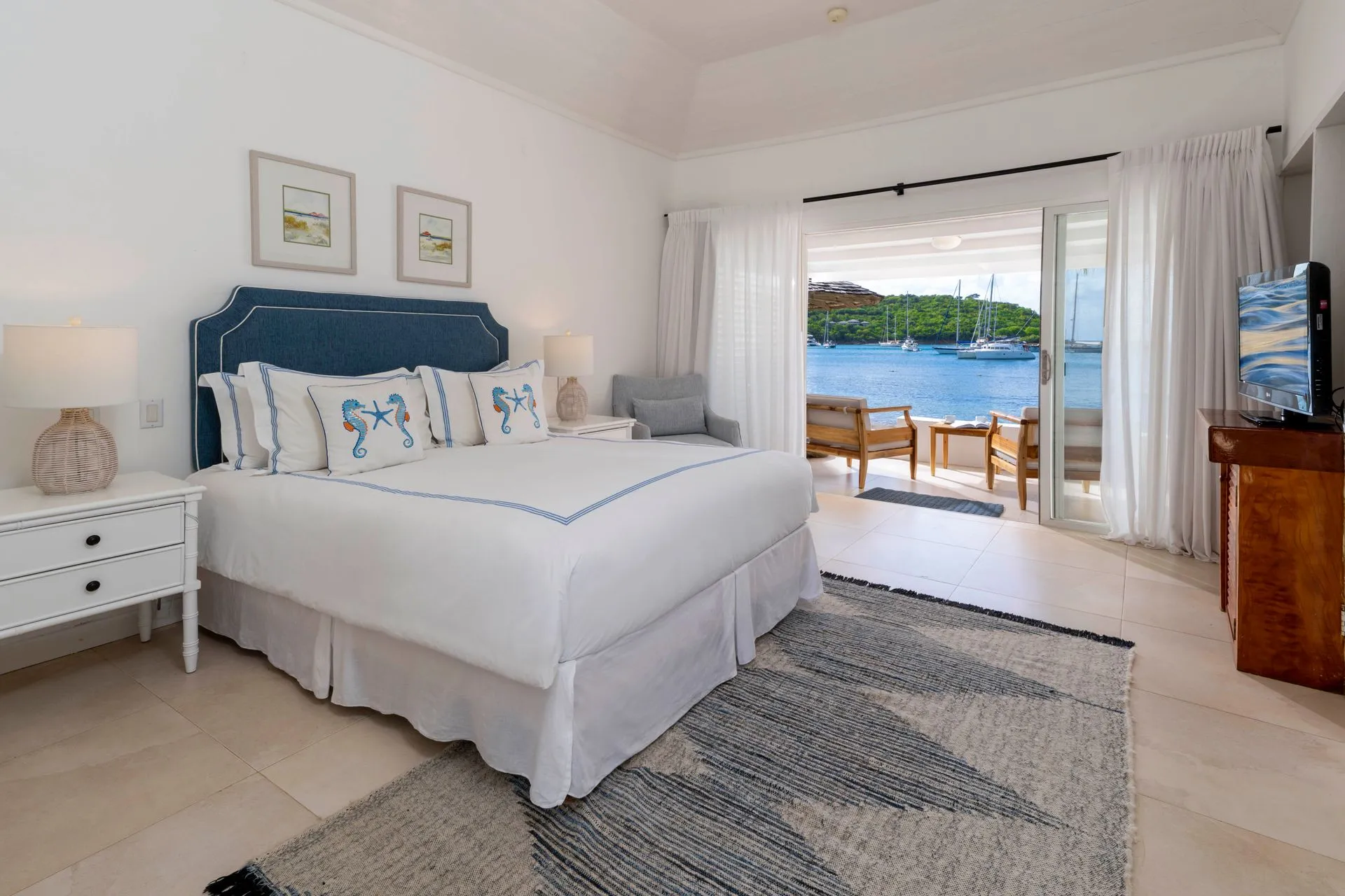 Beach Cabana bedroom with white linens and coastal decor at The Inn at English Harbour